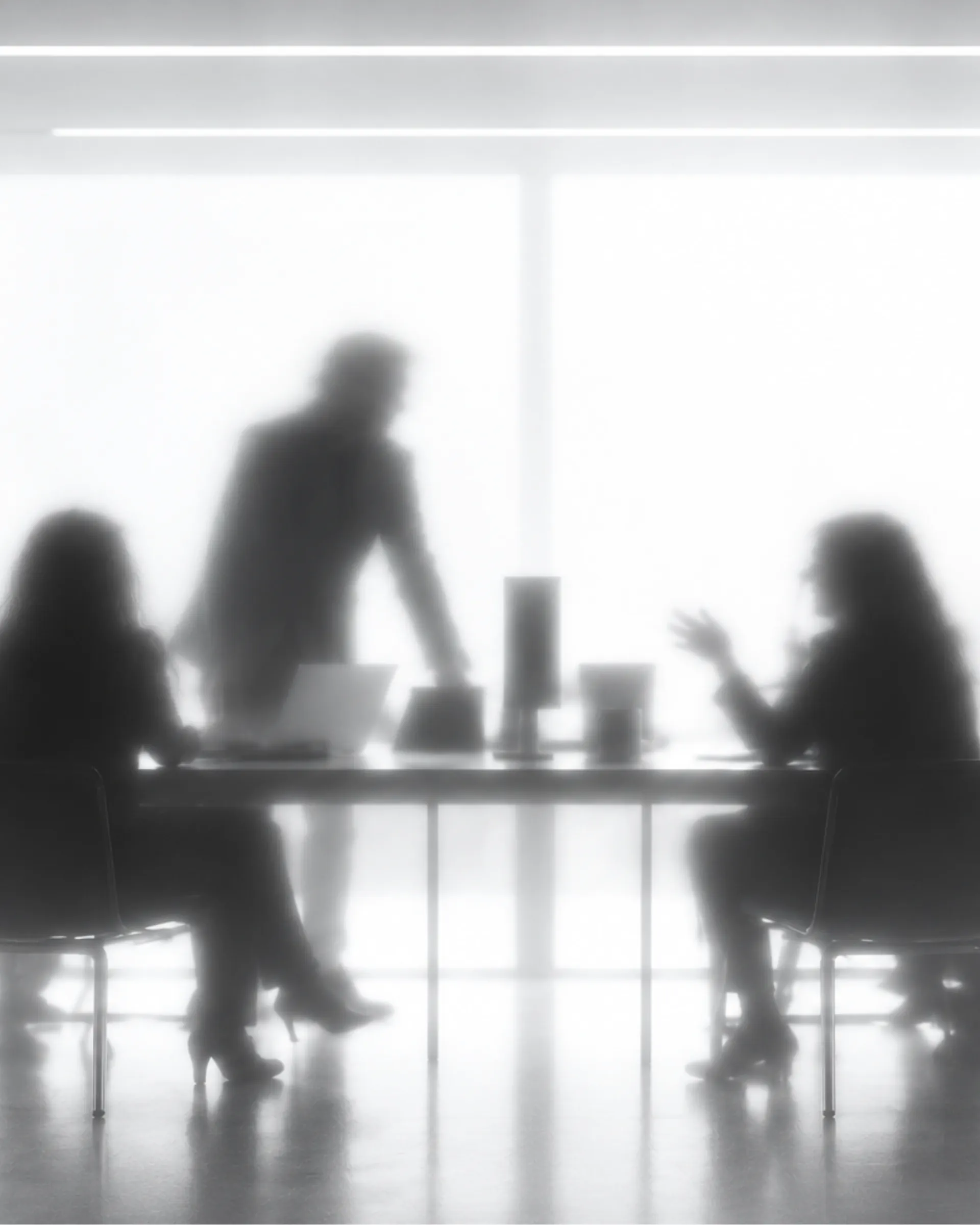Hands pointing at strategy sketches and notes on a dark table